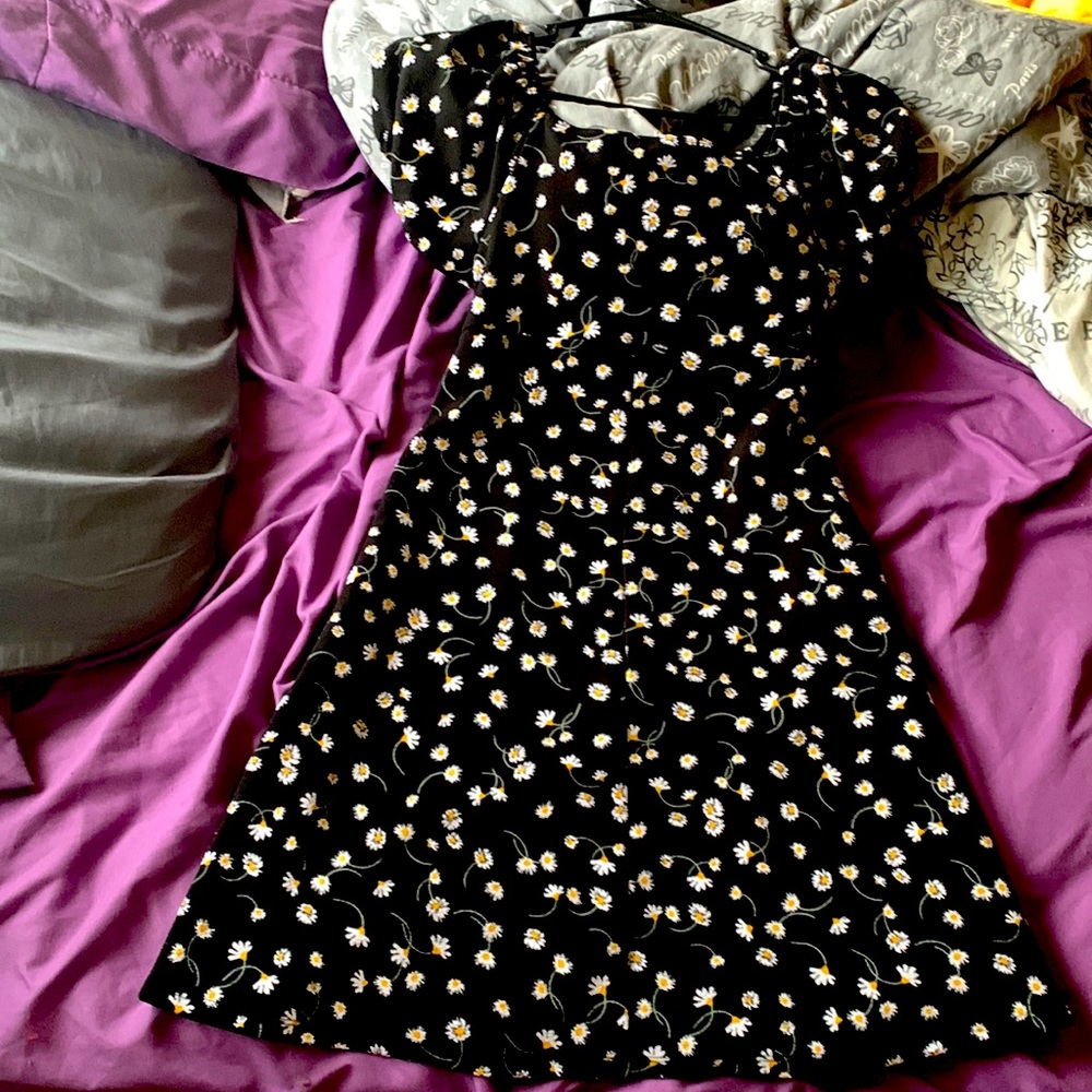 a super cute black dress with white dandelions on it